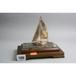 A NOVELTY SAILING BOAT, marked Sterling 960 on a wooden base