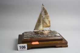 A NOVELTY SAILING BOAT, marked Sterling 960 on a wooden base