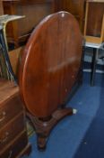 A VICTORIAN MAHOGANY CIRCULAR BREAKFAST TABLE, on a triform base, approximate diameter 100cm and a