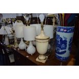 A VICTORIAN WARE BLUE AND WHITE UMBRELLA STAND, with contents, ten various table lamps, one standard