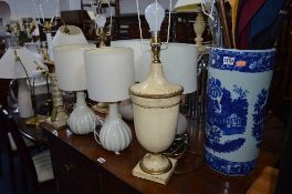 A VICTORIAN WARE BLUE AND WHITE UMBRELLA STAND, with contents, ten various table lamps, one standard