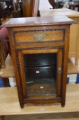 AN OAK GLAZED DISPLAY CABINET, with a single drawer