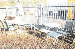 A METAL AND GLASS RECTANGULAR GARDEN TABLE, with four chairs, two loungers, parasol, two d end