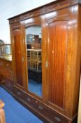 AN EDWARDIAN MAHOGANY FOUR PIECE BEDROOM SUITE, comprising of a double door wardrobe with central