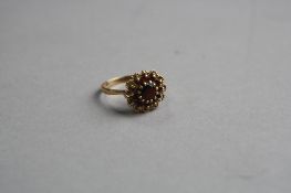A 9CT GARNET CLUSTER RING, ring size O, approximate weight 2.6 grams