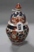 A LATE 19TH CENTURY JAPANESE IMARI BALUSTER VASE AND ASSOCIATED COVER, traditional foliate and