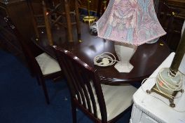 A MAHOGANY EXTENDING DINING TABLE, and four chairs (5)