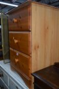 A MODERN PINE BEDSIDE CHEST OF THREE DRAWERS