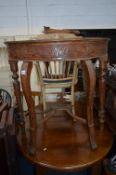 A CARVED MAHOGANY DEMI LUNE HALL TABLE, united by a stretcher (sd)