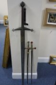 A LARGE 'EXCALIBUR' TYPE SWORD, approximate length 143cm, together with two Spanish swords (one