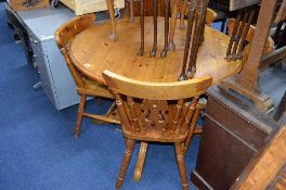 A CIRCULAR PINE TABLE, and four chairs (5)