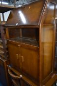 AN OAK BUREAU, two oak buffet stands, three various magazine racks, sewing box, standard lamp,