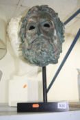 A CAST MYTHICAL HEAD, on stand, approximate height 48cm, together with plaster bust (sd) and a table