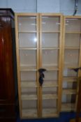 A TALL MODERN BOOKCASE, with two glazed doors, approximate size height 200cm x width 80cm x depth