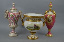 A COALPORT PORCELAIN PINK GROUND AND GILT DECORATED VASE AND COVER, central oval vignettes painted