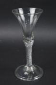 A GEORGE III WINE GLASS, bell shaped bowl, on a stem with clear air twist, height approximately 19.