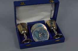 A CASED PAIR OF ELIZABETH II SILVER LICHFIELD CATHEDRAL ANNIVERSARY GOBLETS AND MATCHING COASTERS,