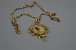 AN EARLY 20TH CENTURY PORTRAIT PENDANT, enclosed within a split pearl and turquoise scroll surmount,