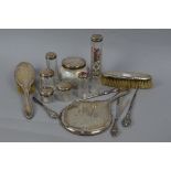 A QUANTITY OF SILVER BACKED AND TOPPED DRESSING TABLE AND MANICURE REQUISITES, includes a hand