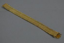 A MODERN FLAT TEXTURED PLAITED SOLID LINK BRACELET, fitted to tongue and box clasp with two