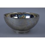 AN ELIZABETH II SILVER CIRCULAR ROSE BOWL, the foot cast with flower head, bead and scroll design,