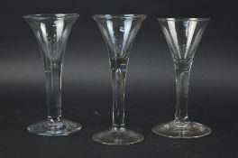 A MID 18TH CENTURY WINE GLASS, bell shaped bowl, plain stem, height approximately 16.5cm, together