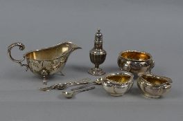 A SECOND HALF OF THE 18TH CENTURY CIRCULAR SILVER SALT, wavy rim, gilt interior, on three cabriole