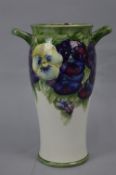 AN EARLY 20TH CENTURY WILLIAM MOORCROFT TWIN HANDLED VASE, of baluster form, decorated in a purple