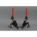 A PAIR OF BRONZE DRAGON CANDLESTICKS, the dragons cast with two front legs, the curled tail acting