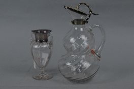 A LATE VICTORIAN SILVER MOUNTED CLEAR GLASS DOUBLE GOURD SHAPED CLARET JUG, swirl effect to glass,