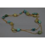 AN EARLY 20TH CENTURY NECKLACE, rope section chain interspaced with alternating turquoise and