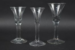 A MID 18TH CENTURY WINE GLASS, funnel shaped bowl, plain stem, slightly domed foot, height