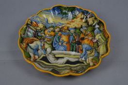 A 19TH CENTURY ITALIAN MAJOLICA DISH OF WAVY CIRCULAR FORM, depictures the burial of Abraham from