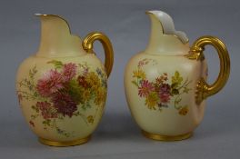 A PAIR OF ROYAL WORCESTER BLUSH IVORY FLATBACK JUGS, gilt handled, painted with cornflowers,