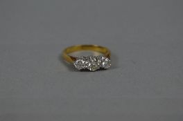 A LATE 20TH CENTURY THREE STONE DIAMOND RING, estimated total modern round brilliant cut weight 0.