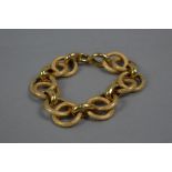 A MODERN LARGE FANCY HOLLOW LINKED BRACELET, textured and polished links, measuring approximately