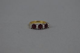 A LATE 20TH CENTURY 18CT GOLD RUBY AND DIAMOND HALF HOOP RING, three oval mixed cut rubies measuring