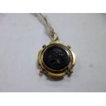 A CORNELIAN CARVED INTAGLIO PENDANT, measuring approximately 20mm in diameter, together with a