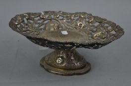 A VICTORIAN SILVER OVAL PEDESTAL DISH, repousse decorated and chased with flowers and foliate