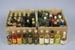A COLLECTION OF OVER ONE HUNDRED MINIATURE BOTTLES OF ASSORTED WHISKIES, SPIRITS AND LIQUEURS, to