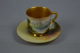 A ROYAL WORCESTER RAYMOND RUSHTON COFFEE CUP AND SAUCER, painted with castles by river landscapes,