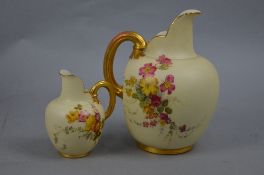 A GRADUATED SET OF TWO ROYAL WORCESTER IVORY GROUND JUGS OF FLATBACK SHAPE, both painted with Summer