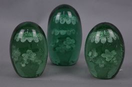 THREE VICTORIAN GREEN GLASS DUMP WEIGHTS, the larger with two tier fountain above flowers inclusion,
