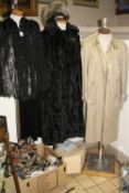 A BLACK LACE/BEADED CAPE, two raincoats, fur hat, faux fur coat, a rug from Oriental carpet
