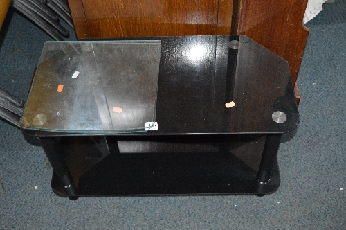 A BLACK GLASS TV STAND