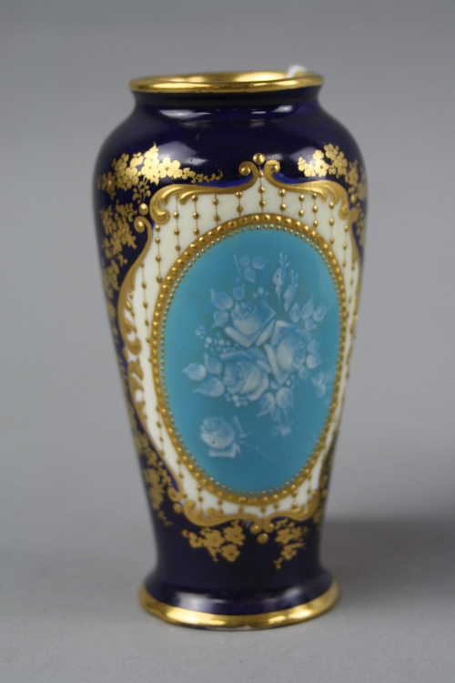 A SMALL DOULTON BURSLEM VASE, with pate-sur-pate insert on blue ground with gilt decoration, green