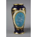 A SMALL DOULTON BURSLEM VASE, with pate-sur-pate insert on blue ground with gilt decoration, green