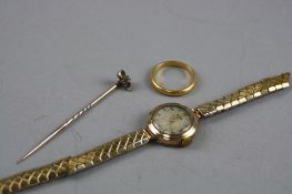 A 22CT BAND, ring size N, approximate weight 3.8 grams, a gem stick pin and a ladies gold watch head