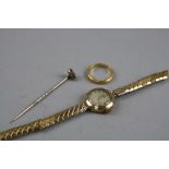 A 22CT BAND, ring size N, approximate weight 3.8 grams, a gem stick pin and a ladies gold watch head