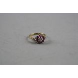 A 9CT RUBY AND DIAMOND CLUSTER RING, 2.4 grams, ring size N